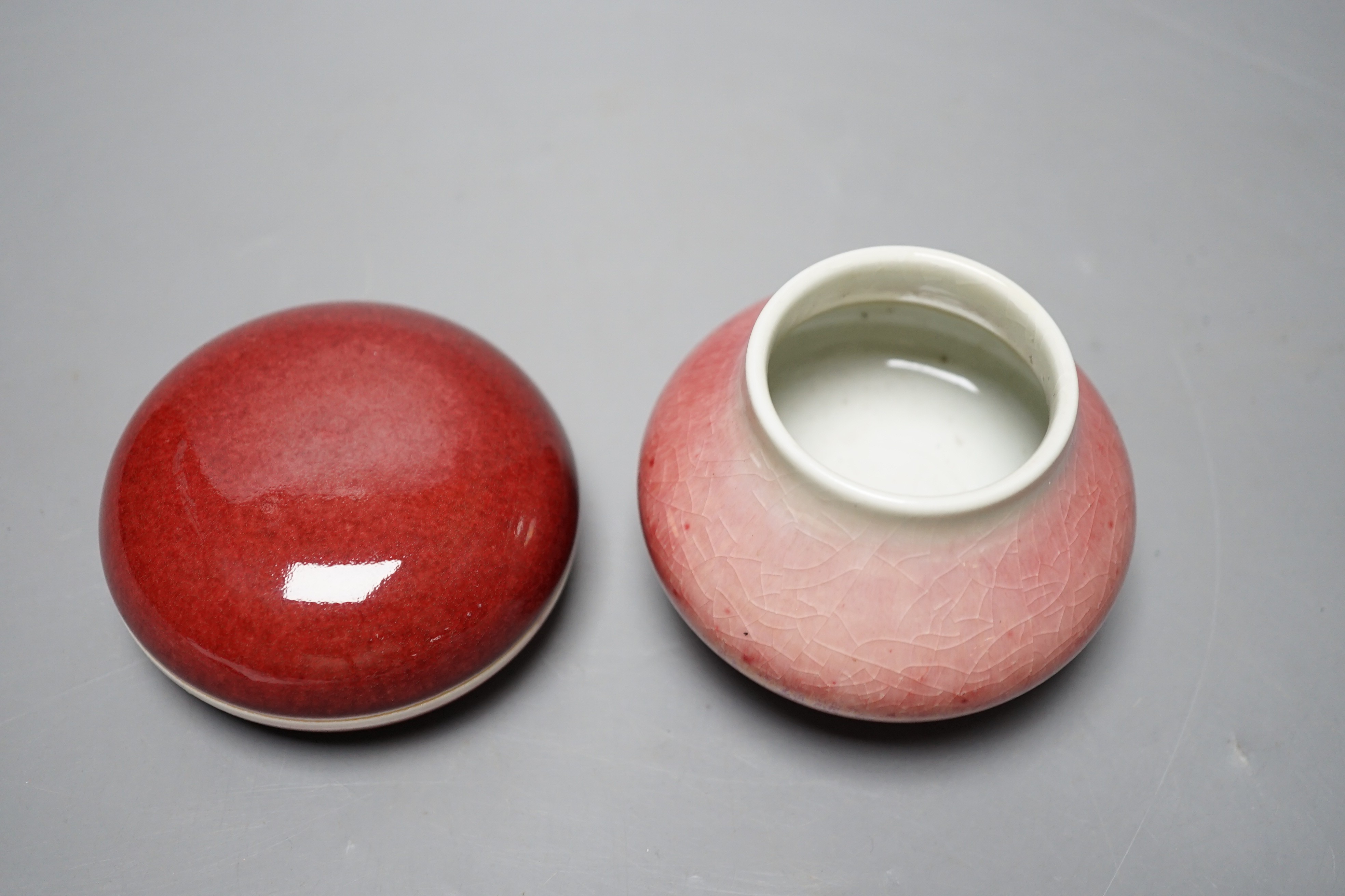 A Chinese sang de boeuf glazed seal paste box and a small pot (2) box 7.5cm diameter